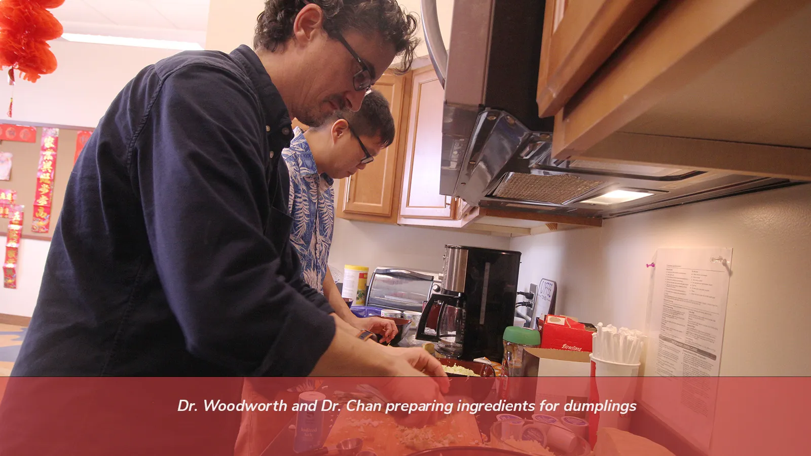 Dr Woodworth and Dr. Chan preparing ingredients for dumplings